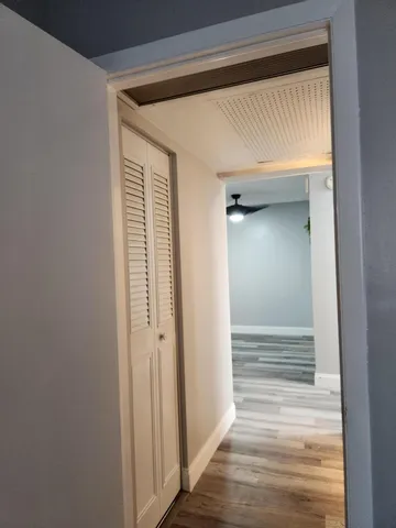 a green bench sitting in front of a window