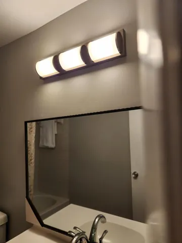 a view of a hallway to a livingroom and a dining room with furniture