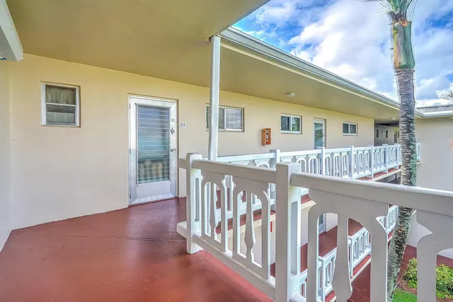 a view of a house with wooden deck