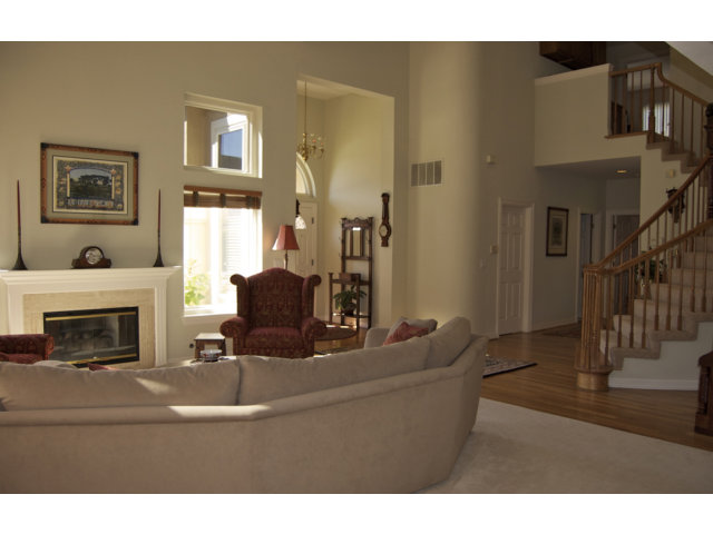 361 Eagle Trace Drive Half Moon Bay, CA 94019 - Photo 12 of 25 a living room with furniture a fireplace and a flat screen tv