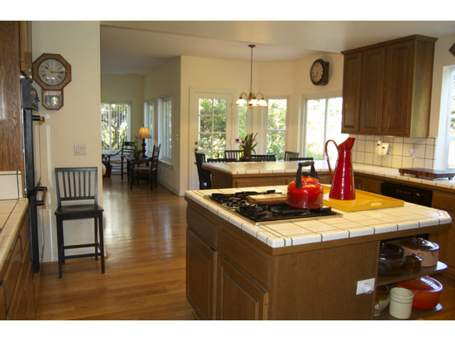 361 Eagle Trace Drive Half Moon Bay, CA 94019 - Photo 3 of 25 a dining room with furniture a large window and a chandelier