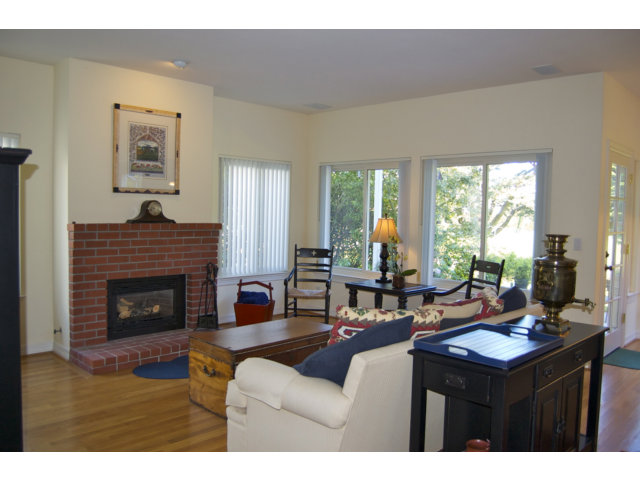 361 Eagle Trace Drive Half Moon Bay, CA 94019 - Photo 5 of 25 a living room with furniture a fireplace and large windows