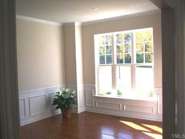 204 Forbes Road Wake Forest, NC 27587 - Photo 3 of 12 This Formal Living Room is just off the foyer entry and offers elegant crown, chair rail, picture frame molding and hardwood floors.