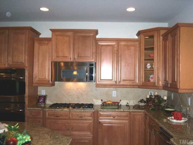 204 Forbes Road Wake Forest, NC 27587 - Photo 4 of 12 This showcase kitchen boasts high-end maple cabinets and cherry island with dovetail drawer construction. This is just a portion of this fabulous kitchen layout with stainless steel 5 burner gas cooktop, double wall ovens and built in microwave.
