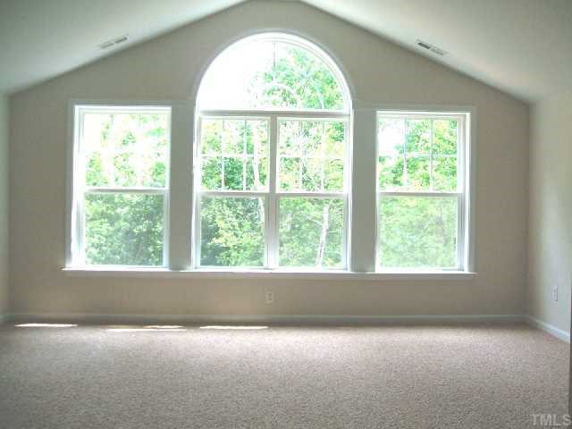 204 Forbes Road Wake Forest, NC 27587 - Photo 7 of 12 This large Playroom on the second floor has a vaulted ceiling and wonderful windows to enjoy the wooded view.