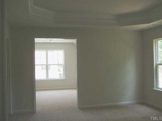 204 Forbes Road Wake Forest, NC 27587 - Photo 8 of 12 Master Suite with sitting room, tray ceiling w/crown molding and two large walk-in closets.