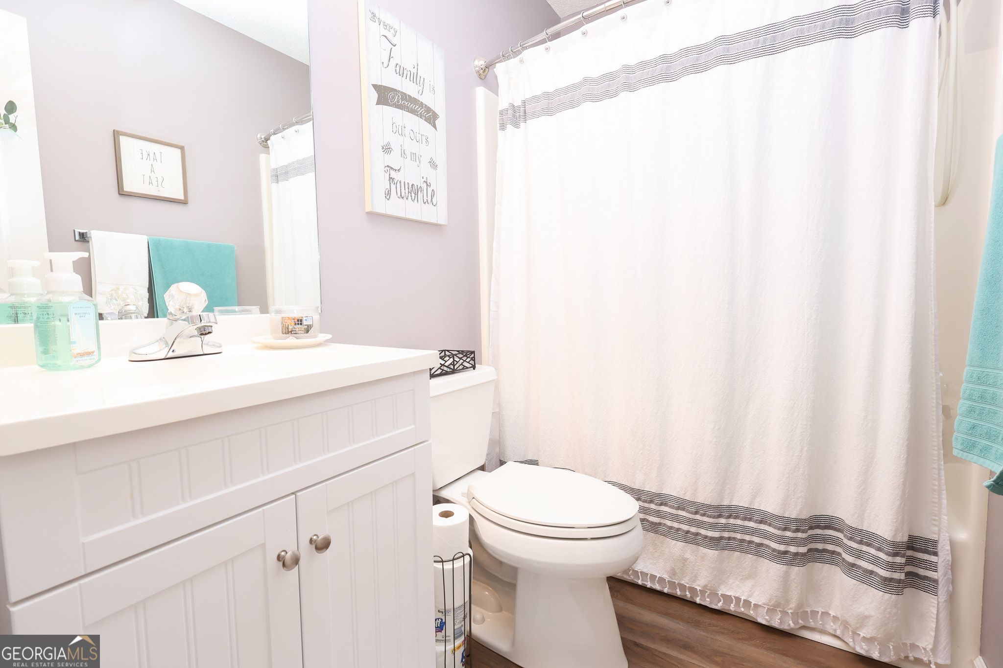 215 Stonefield Circle Macon, GA 31216 - Photo 16 of 26 a bathroom with a sink a toilet and shower curtain