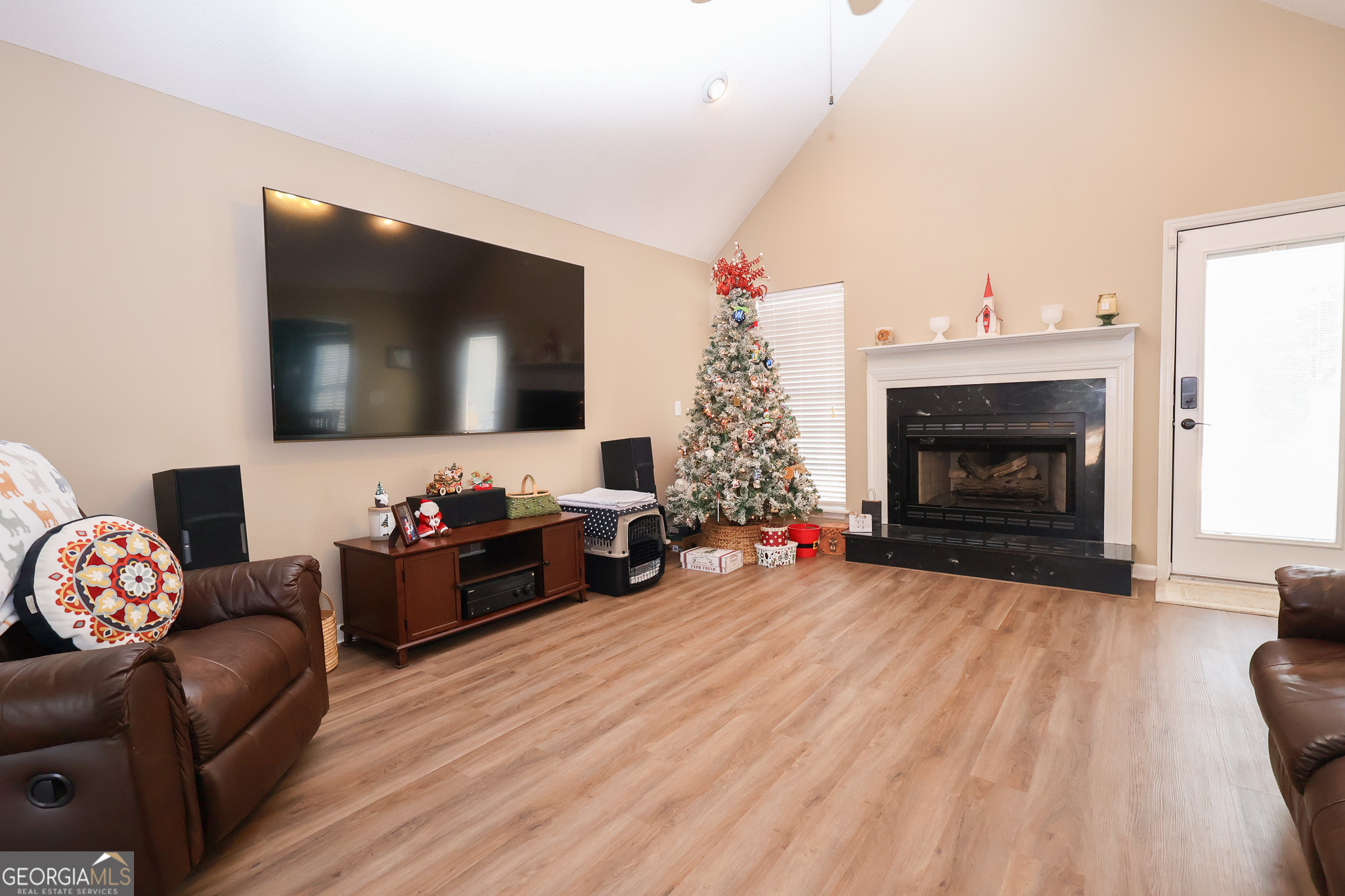 215 Stonefield Circle Macon, GA 31216 - Photo 5 of 26 a living room with furniture a fireplace and a flat screen tv