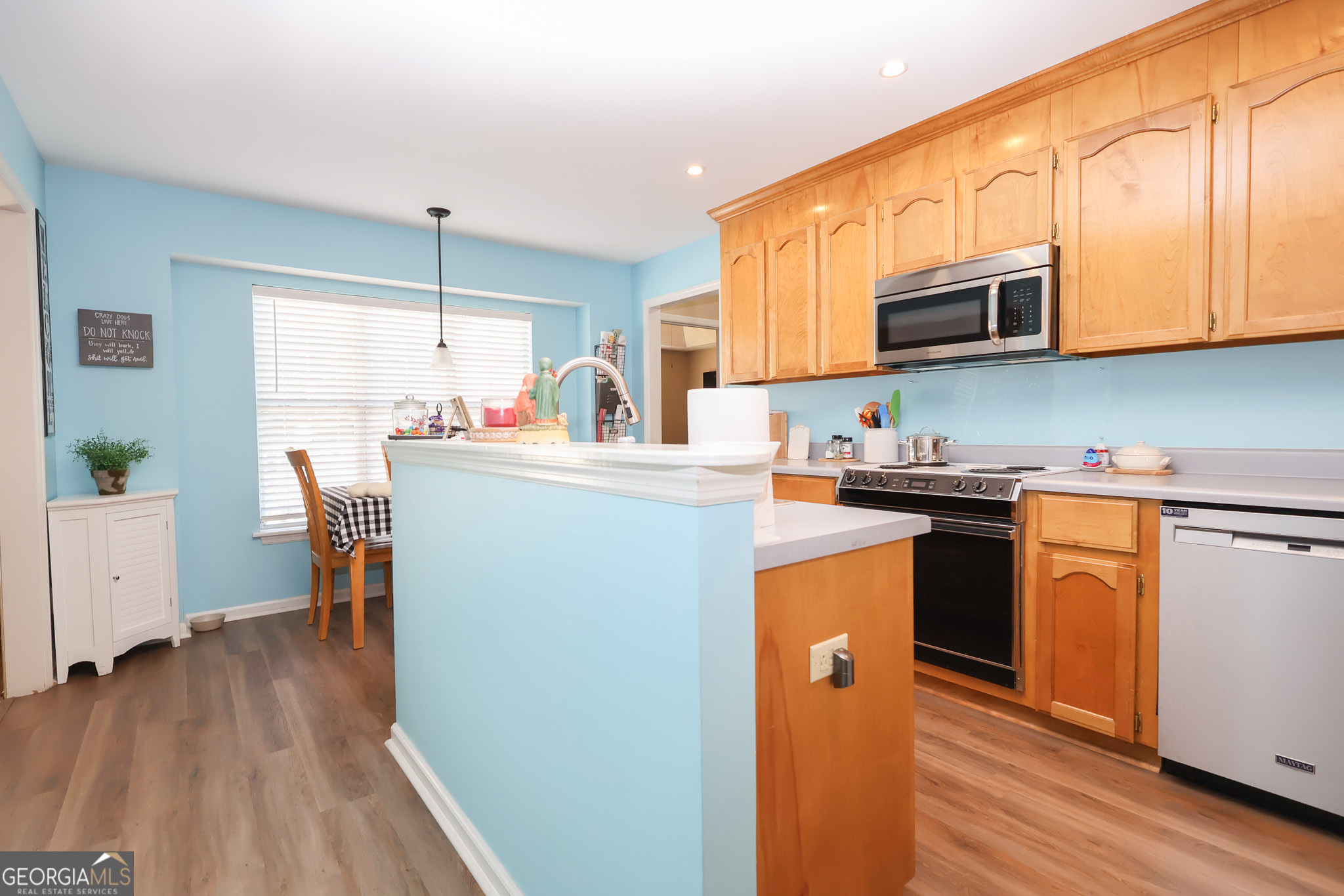 215 Stonefield Circle Macon, GA 31216 - Photo 7 of 26 a kitchen with stainless steel appliances granite countertop a refrigerator a stove top oven a sink dishwasher and white cabinets with wooden floor