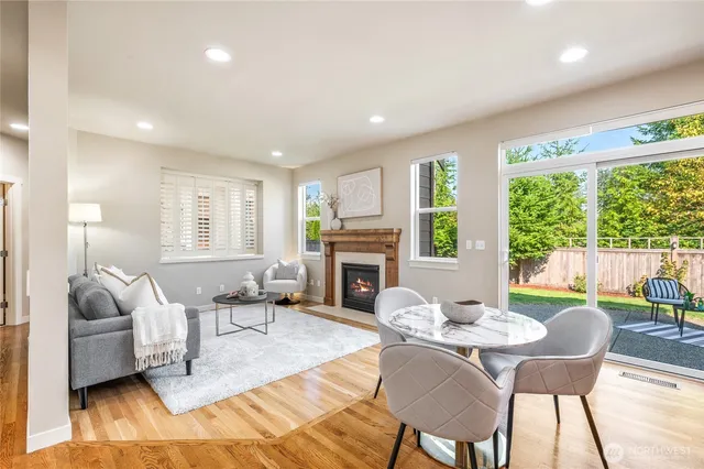 a living room with fireplace furniture and a large window