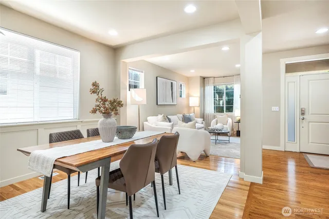 a living room with furniture a wooden floor and next to a window