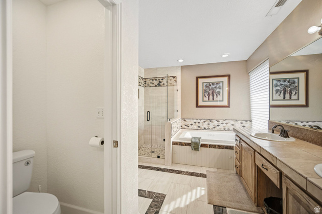 1985 West Rivers Edge Lane St. George, UT 84770 - Photo 25 of 42 Full bathroom with a stall shower, double vanity, a bath, light tile patterned floors, and recessed lighting