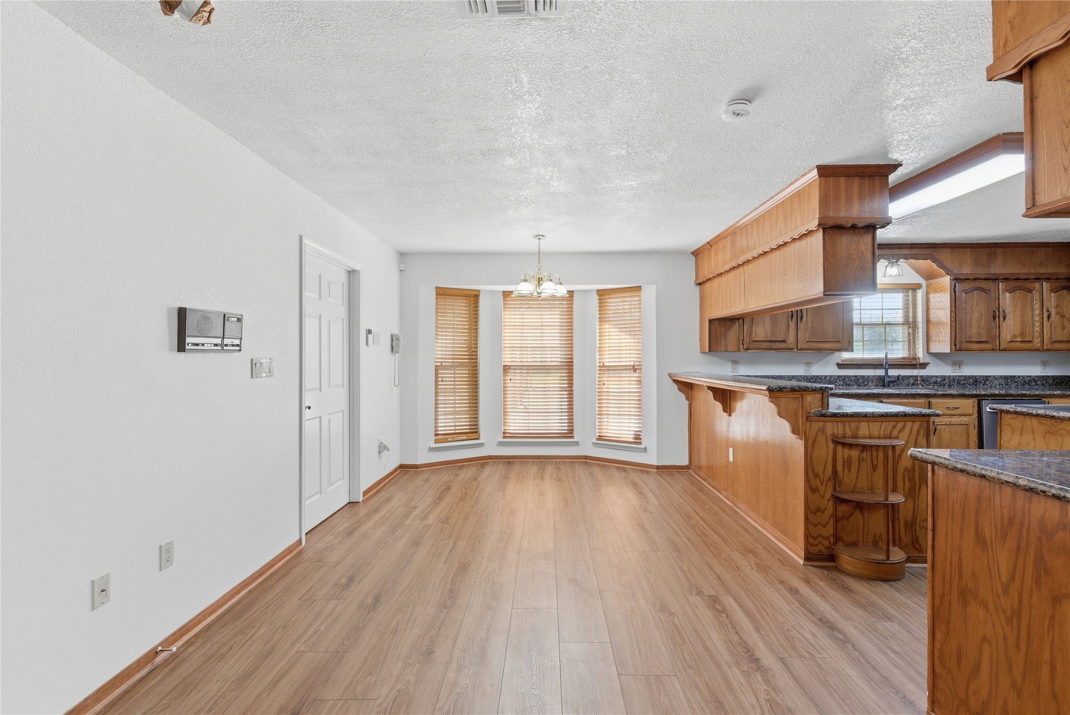 436 County Road 502A Sweeny, TX 77480 - Photo 12 of 45 a open kitchen with granite countertop a stove top oven a sink and dishwasher with wooden floor