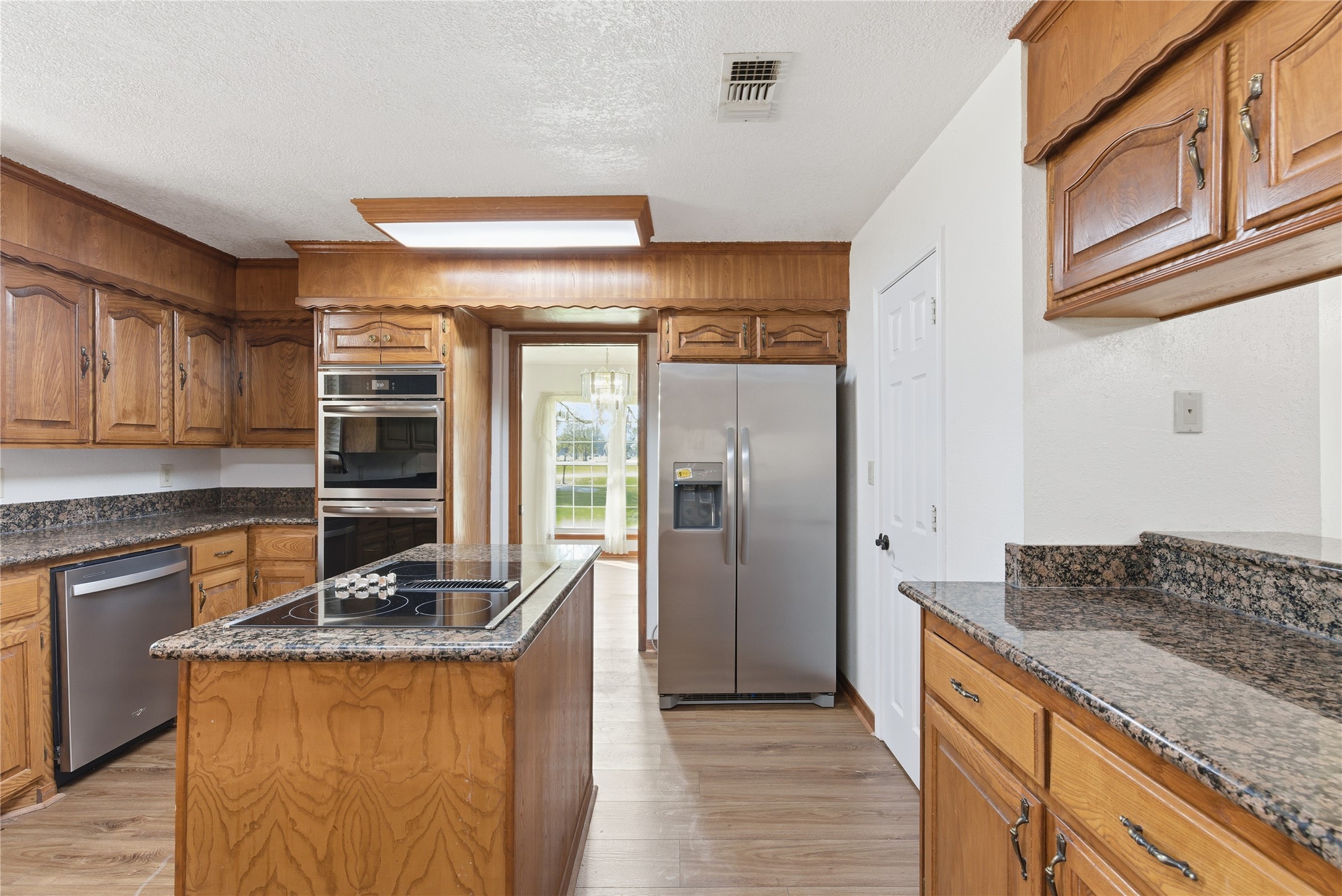 436 County Road 502A Sweeny, TX 77480 - Photo 13 of 45 a kitchen with granite countertop a refrigerator and a stove top oven
