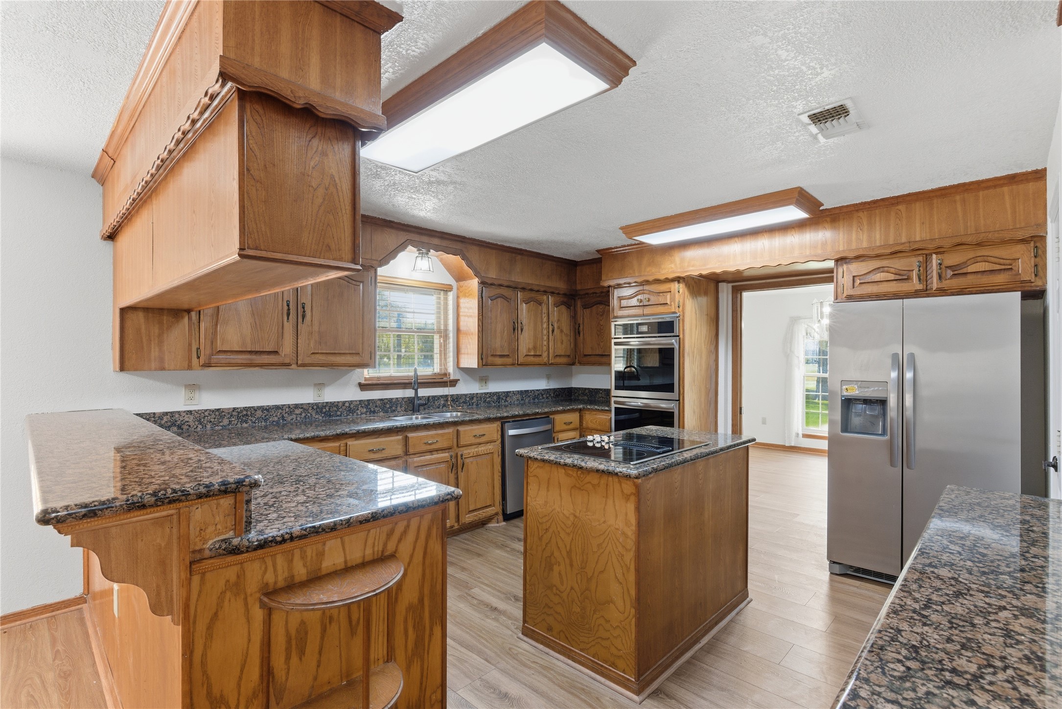 436 County Road 502A Sweeny, TX 77480 - Photo 14 of 45 a kitchen with stainless steel appliances granite countertop a sink stove and refrigerator