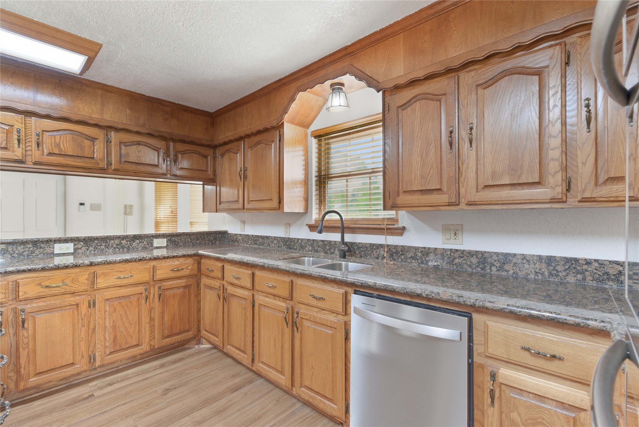 436 County Road 502A Sweeny, TX 77480 - Photo 18 of 45 a kitchen with stainless steel appliances granite countertop a sink and cabinets with wooden floor