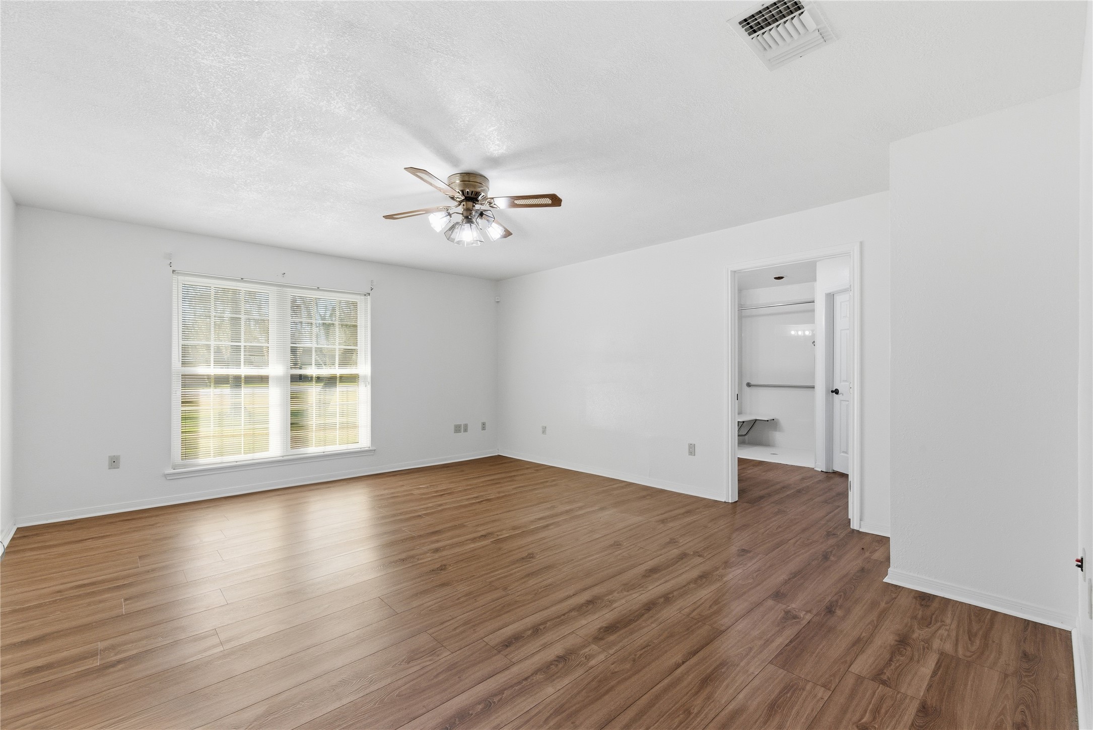 436 County Road 502A Sweeny, TX 77480 - Photo 23 of 45 an empty room with wooden floor and windows