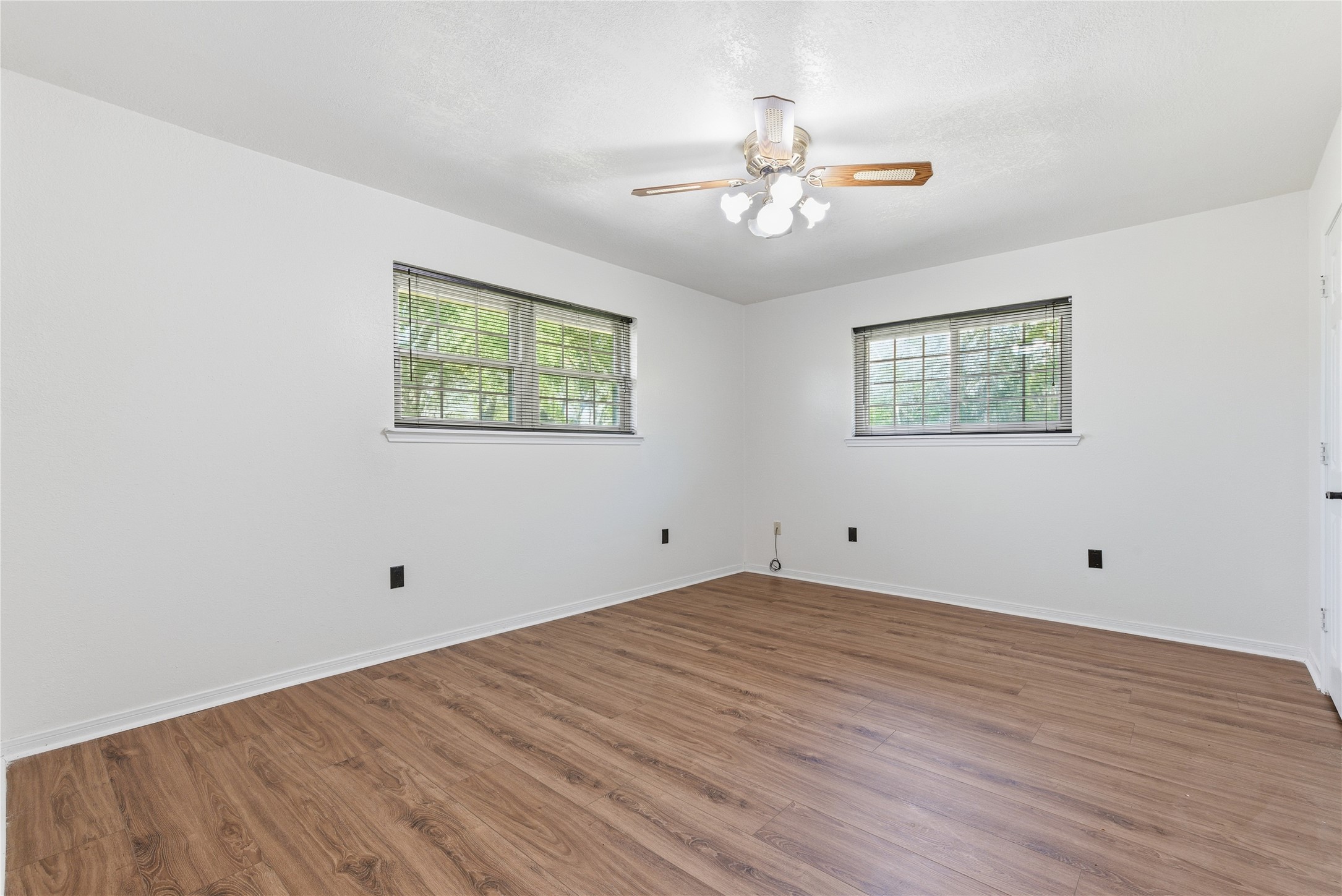 436 County Road 502A Sweeny, TX 77480 - Photo 33 of 45 a view of an empty room with wooden floor and a chandelier