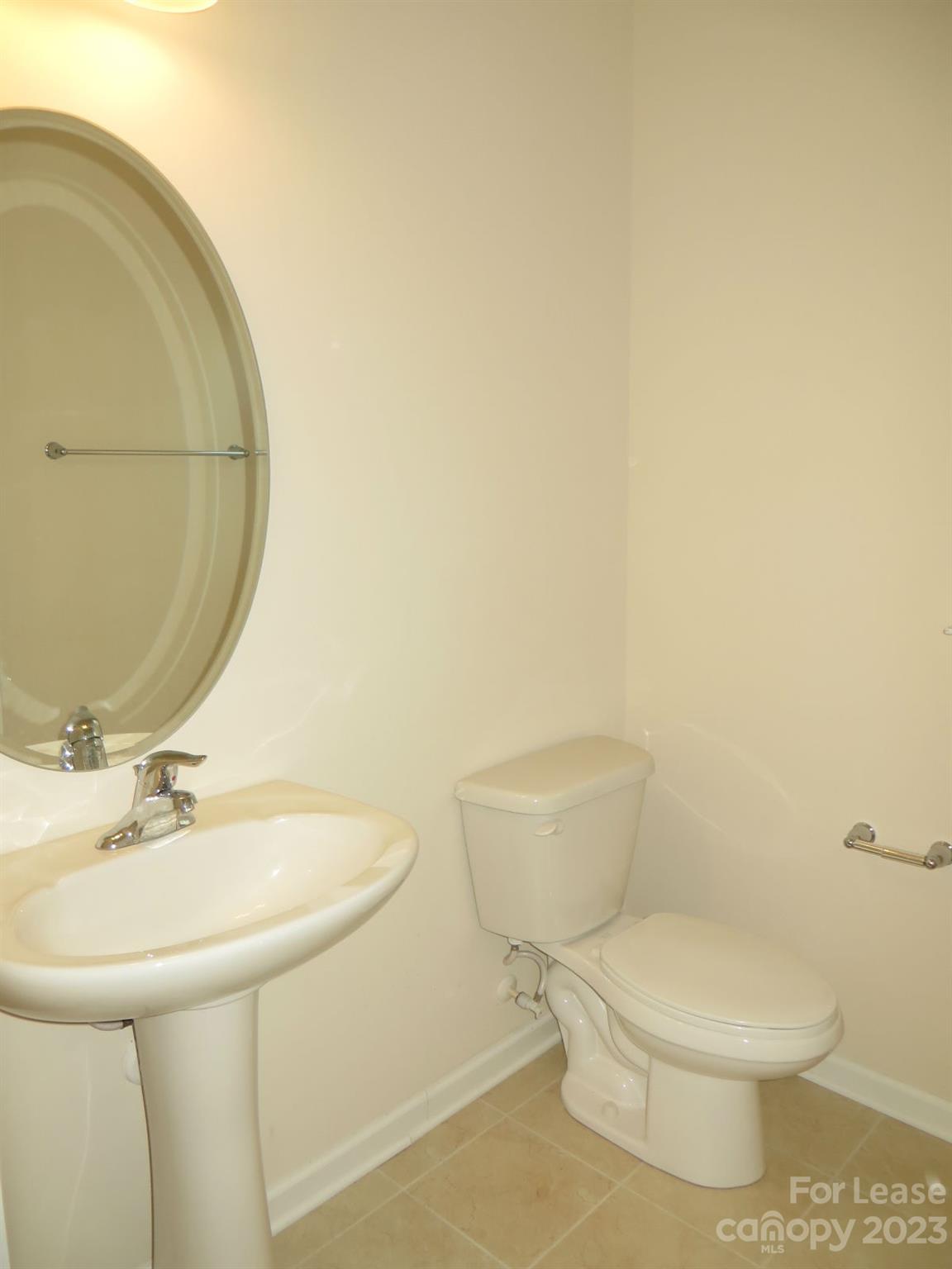 5107 Waterloo Drive Tega Cay, SC 29708 - Photo 11 of 25 a white toilet sitting next to a bathroom sink