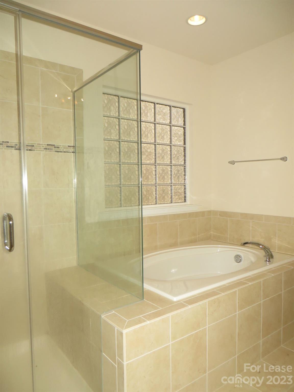 5107 Waterloo Drive Tega Cay, SC 29708 - Photo 16 of 25 a bathroom with a bathtub and shower