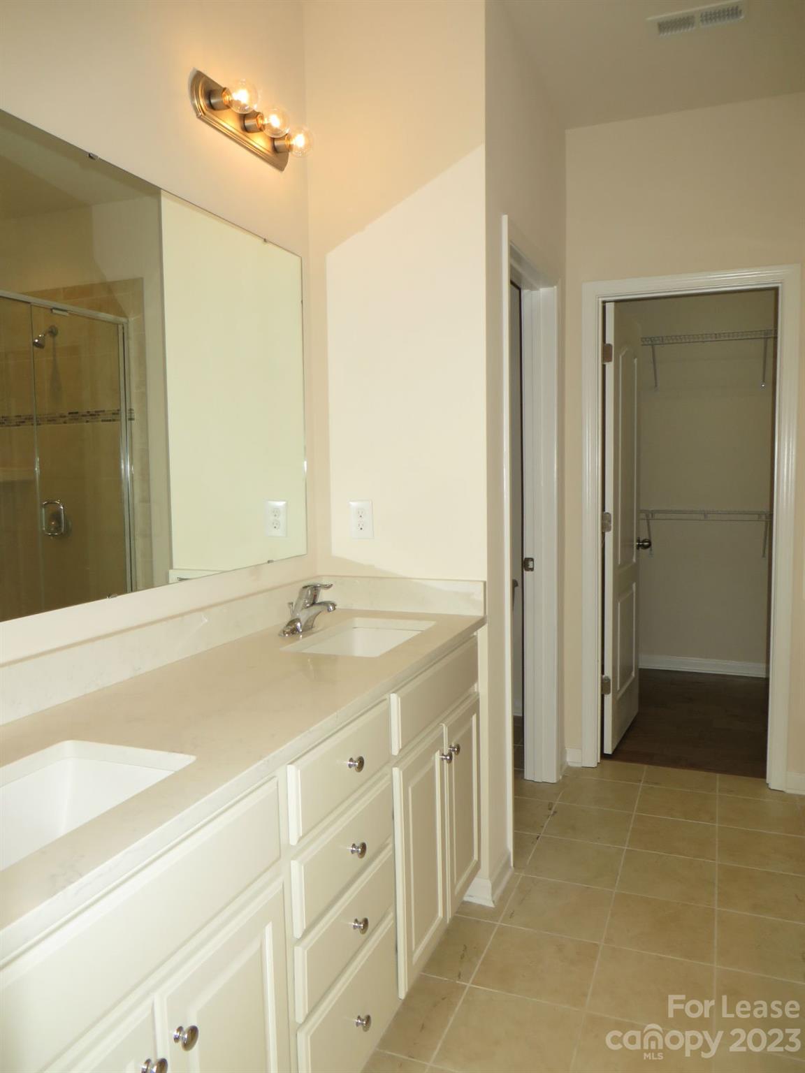 5107 Waterloo Drive Tega Cay, SC 29708 - Photo 17 of 25 a bathroom with a granite countertop sink mirror and shower