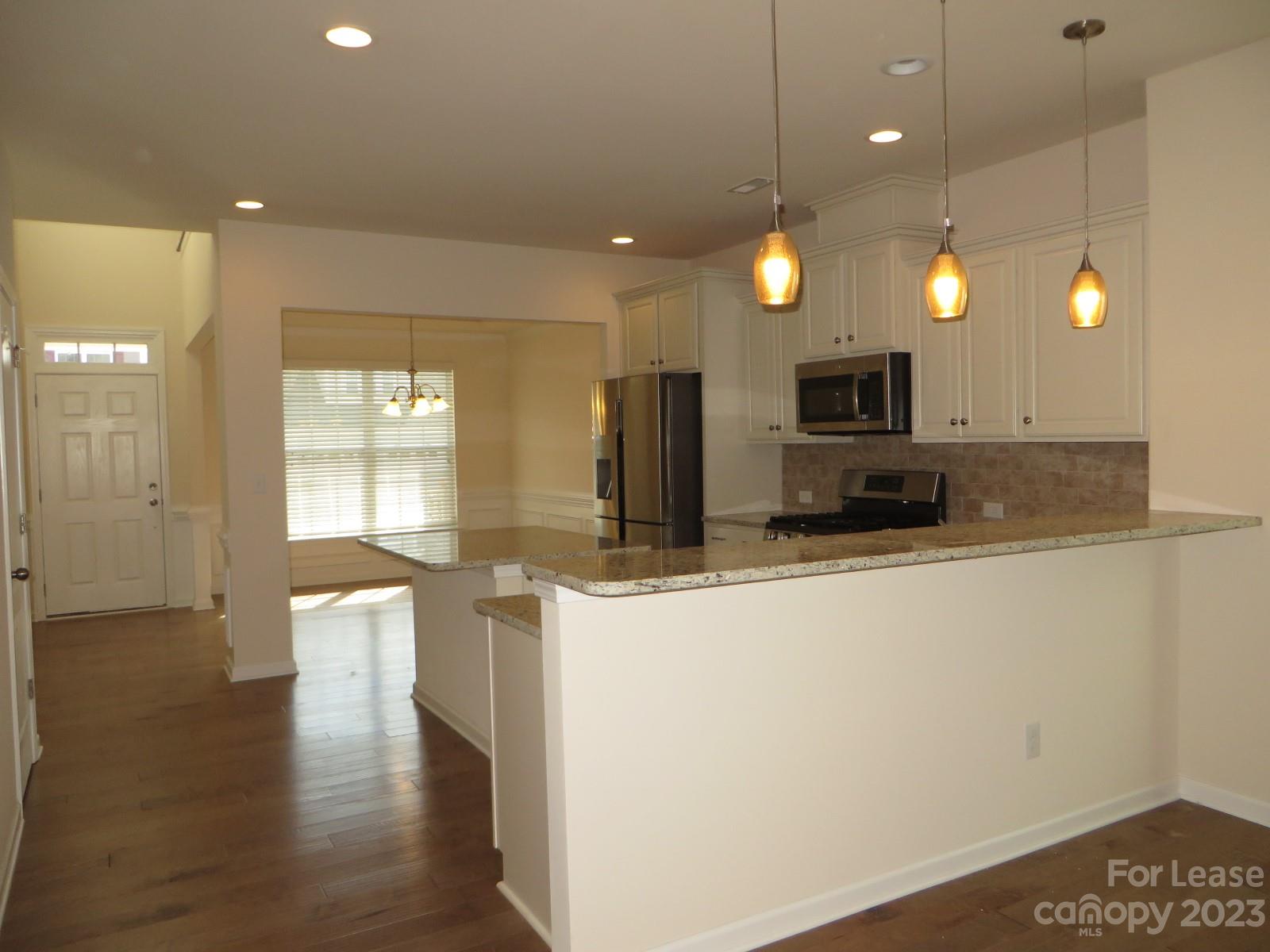 5107 Waterloo Drive Tega Cay, SC 29708 - Photo 5 of 25 a view of a kitchen with kitchen island a sink stainless steel appliances and cabinets