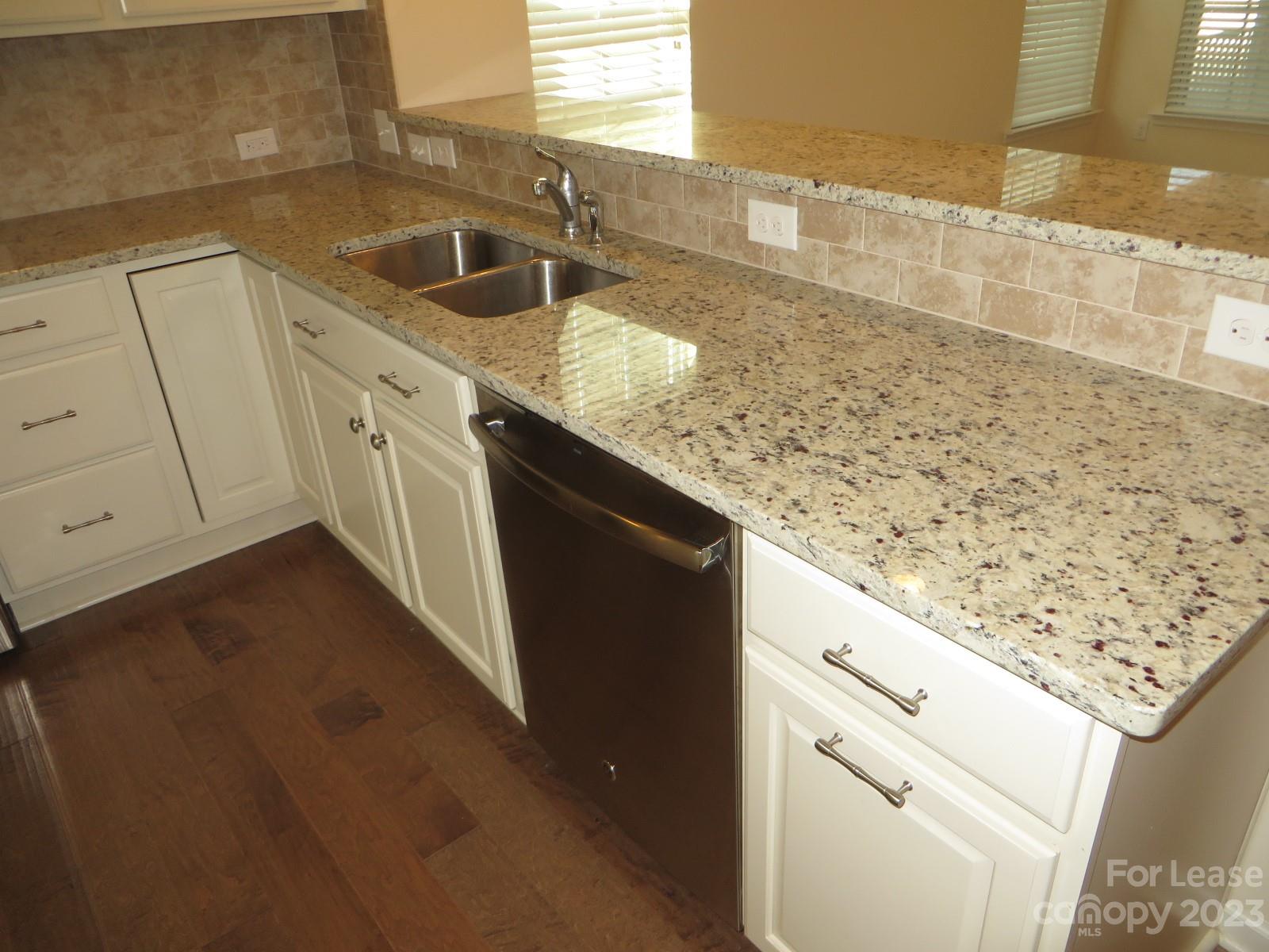5107 Waterloo Drive Tega Cay, SC 29708 - Photo 6 of 25 a kitchen with granite countertop a sink and a stove