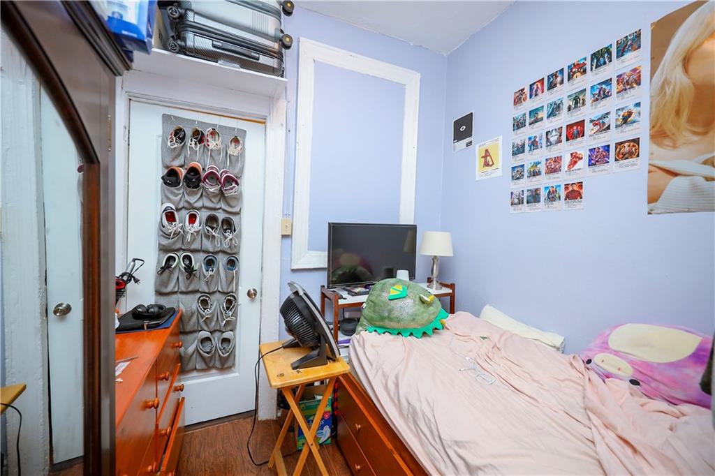 463 52nd Street Brooklyn, NY 11220 - Photo 13 of 22 a bedroom with a bed and a chair