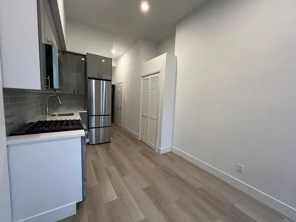 a kitchen with stainless steel appliances a stove a microwave and a refrigerator