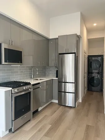 a kitchen with a refrigerator and a sink