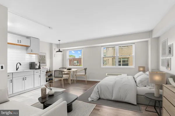 a spacious bedroom with a bed and wooden floor
