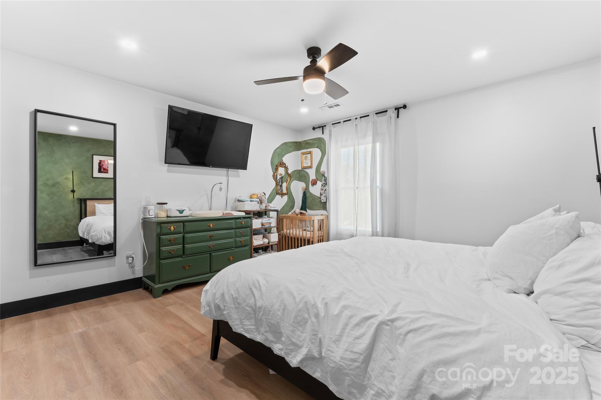 5501 Joyce Drive Charlotte, NC 28215 - Photo 15 of 35 a bedroom with a bed and a flat screen tv