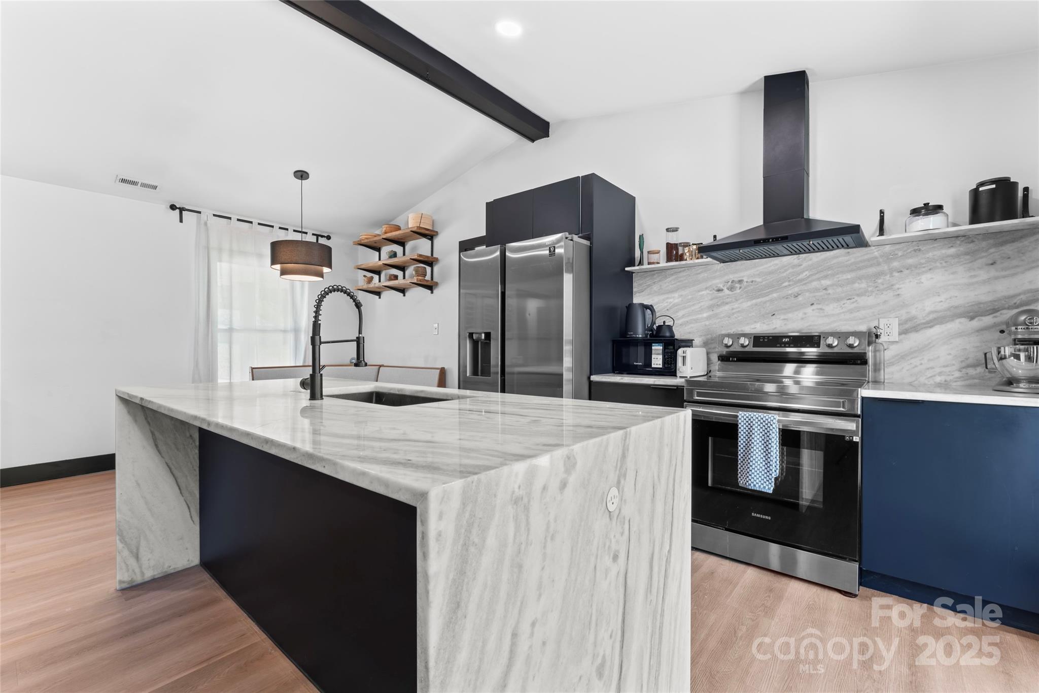 5501 Joyce Drive Charlotte, NC 28215 - Photo 2 of 35 a kitchen with stainless steel appliances kitchen island a sink stove and refrigerator