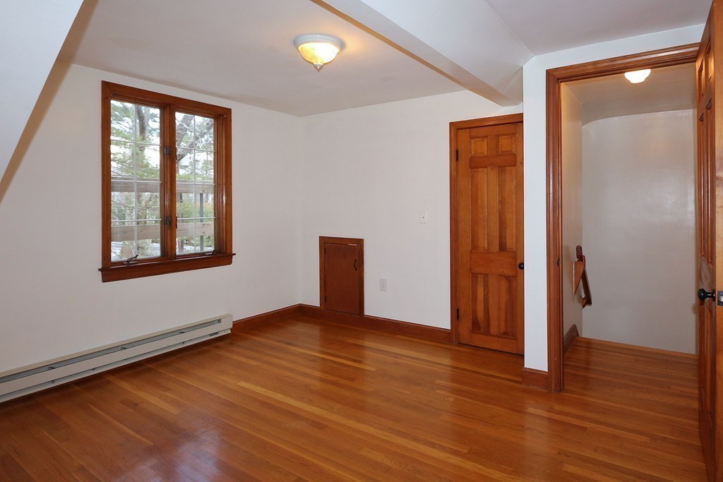 557 Dutton Road, Unit 3 Sudbury, MA 01776 - Photo 5 of 13 an empty room with wooden floor and windows