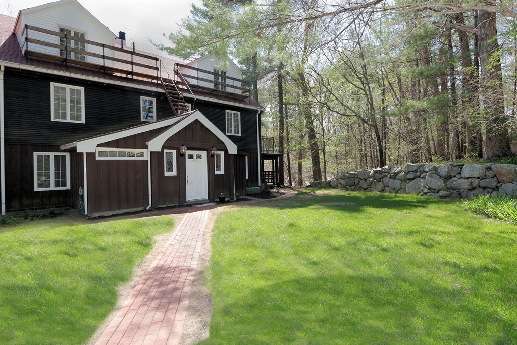 557 Dutton Road, Unit 3 Sudbury, MA 01776 - Photo 9 of 13 a front view of a house with a garden