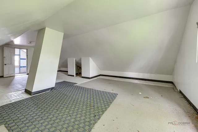 an empty room with windows and cabinet