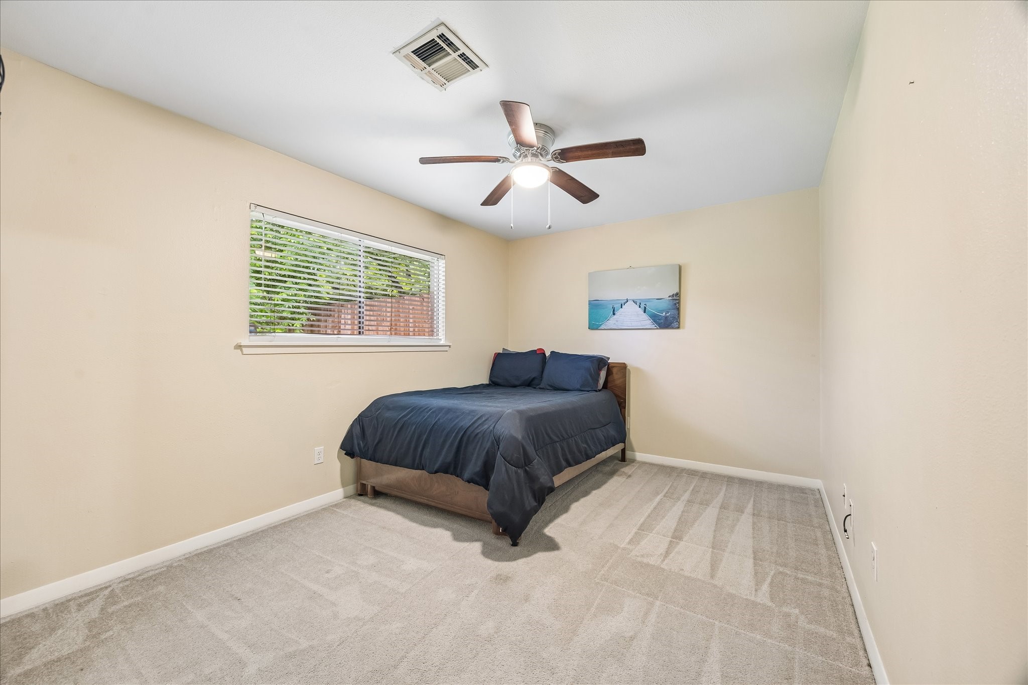 5526 Grape Street Houston, TX 77096 - Photo 8 of 10 a spacious bedroom with a bed and a window