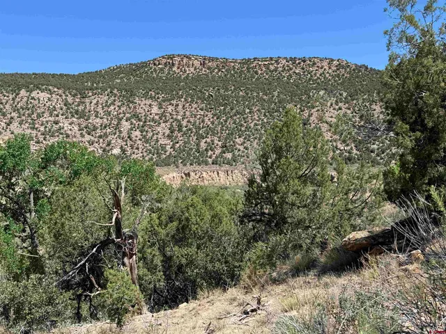 a view of a large building with mountains in the background