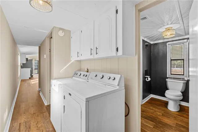 a bathroom with a sink a toilet a mirror and shower