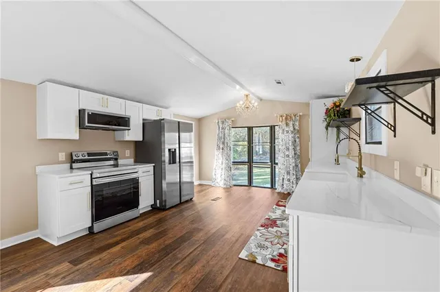 a kitchen with a stove a sink and a refrigerator