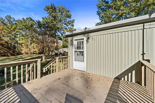 a view of a house with a big yard and large trees