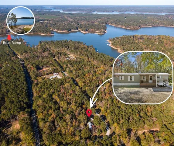 an aerial view of a house with backyard space and a lake view