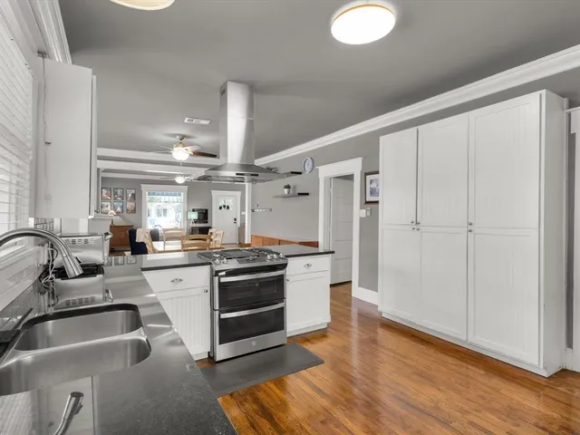 a kitchen with stainless steel appliances granite countertop a sink and a refrigerator