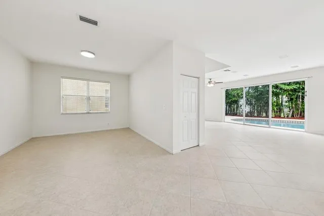 an empty room with windows and view of an empty room