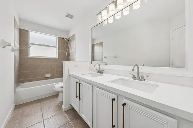 a bathroom with a sink a toilet and bathtub