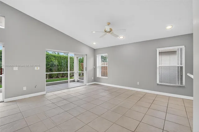 a view of a kitchen with microwave and refrigerator