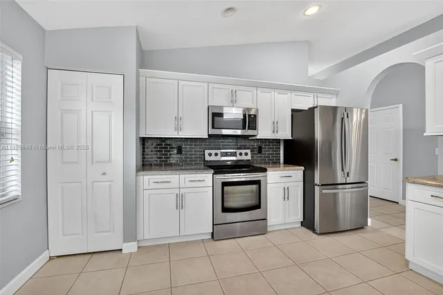 a view of a livingroom with a ceiling fan and window
