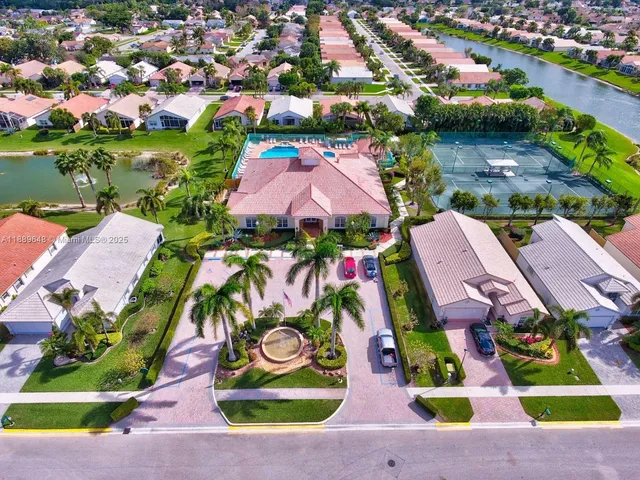 an aerial view of a house with outdoor space pool patio and lake view