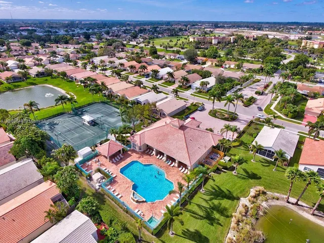 a view of a patio with couches table and chairs with plants
