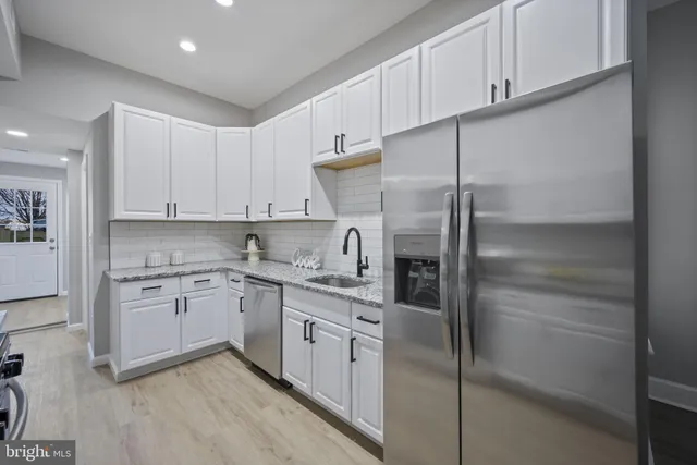 a kitchen with cabinets and stainless steel appliances